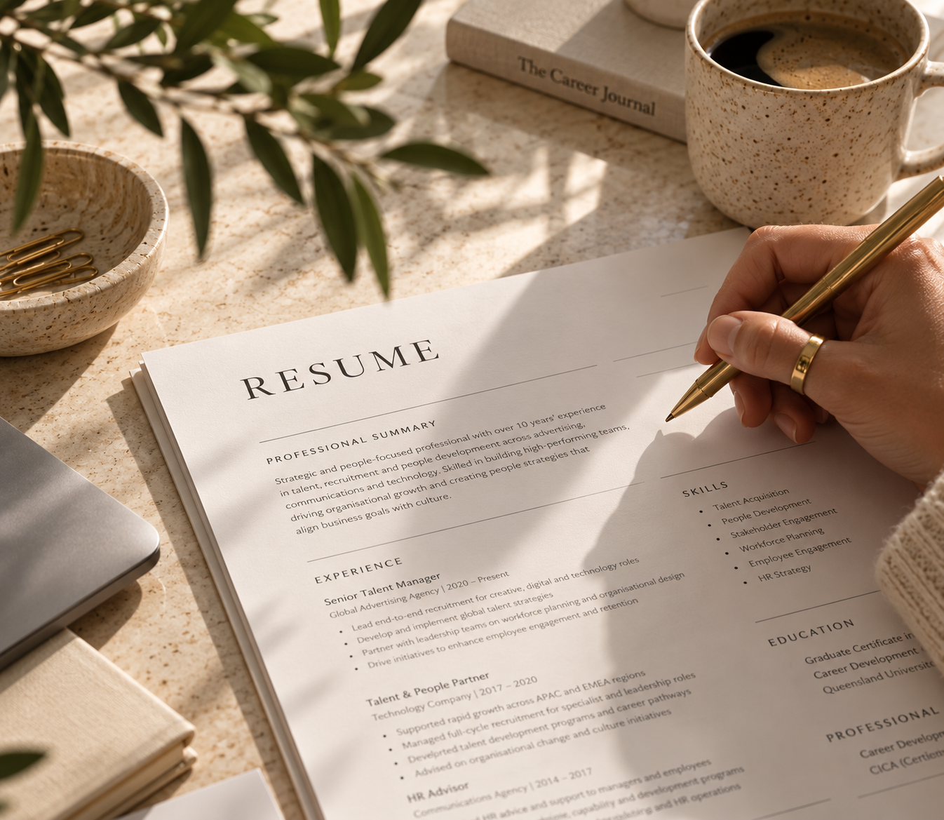 A résumé being edited by hand at a sunlit workspace